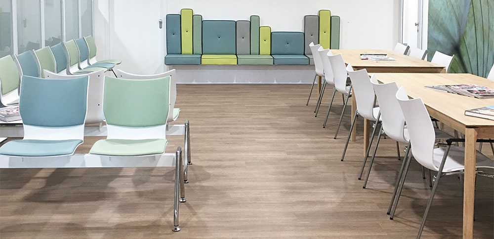 Wachtkamerinrichting met gekleurde wachtkamerbanken, bijpassende wachtkamerstoelen en gepersonaliseerde wachtkamerbank Wachtkamerinrichting met gekleurde wachtkamerbanken, bijpassende wachtkamerstoelen en gepersonaliseerde wachtkamerbank